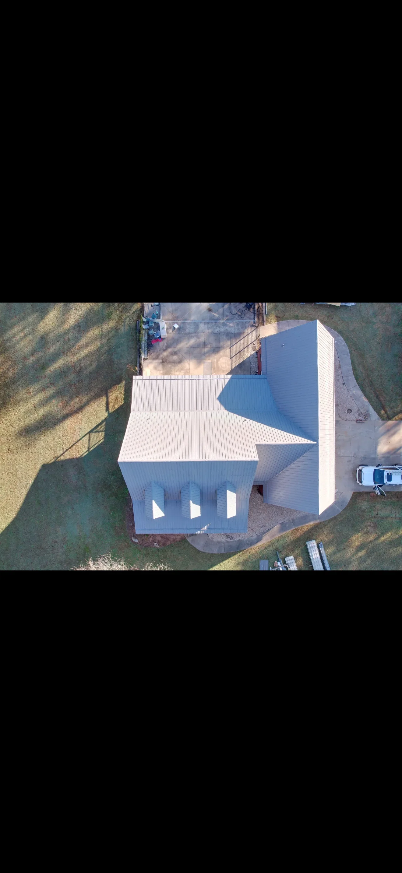 Aerial view of white metal roof installation on modern residential building in Shelby, NC