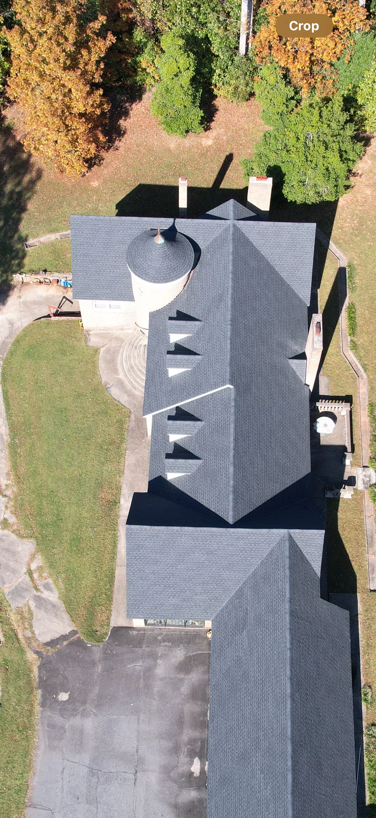 Aerial view of residential home with new gray architectural shingle roof and multiple gables